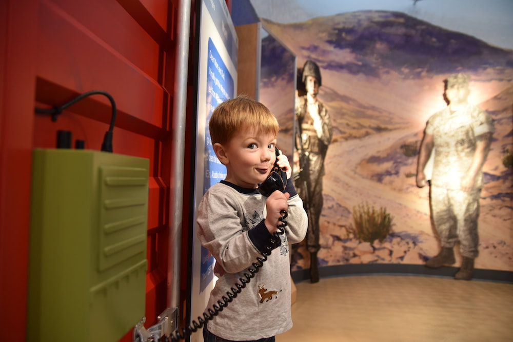 Young boy using the phone in the Children's Gallery