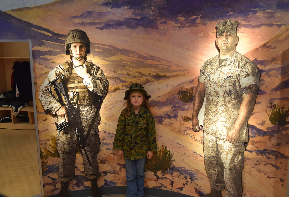 Little girl dressed up in Marine gear in the Children's Gallery
