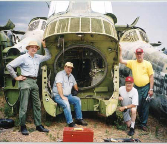 4 members of the Marine Helicopter Squadron 361 Veterans Association in front of the UH-34D