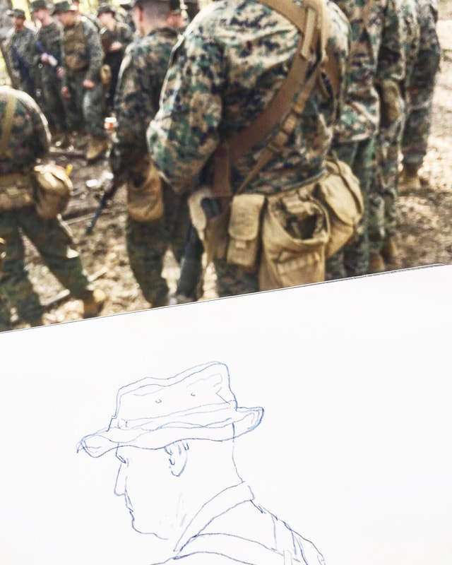 The beginning of a sketch of a Marine on a white page with Marines in the background of the